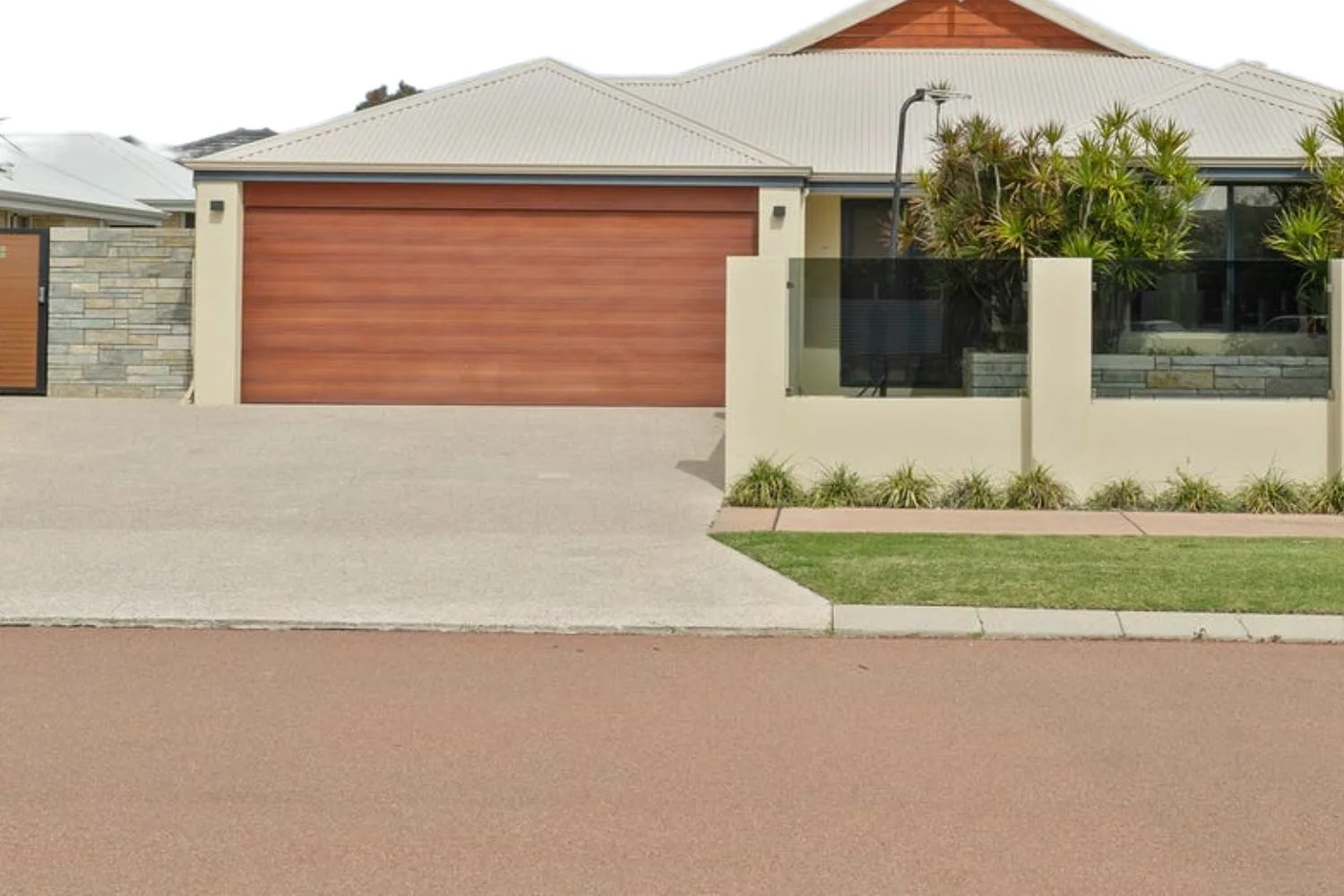 Concrete crossover and driveway connecting the street to a new home
