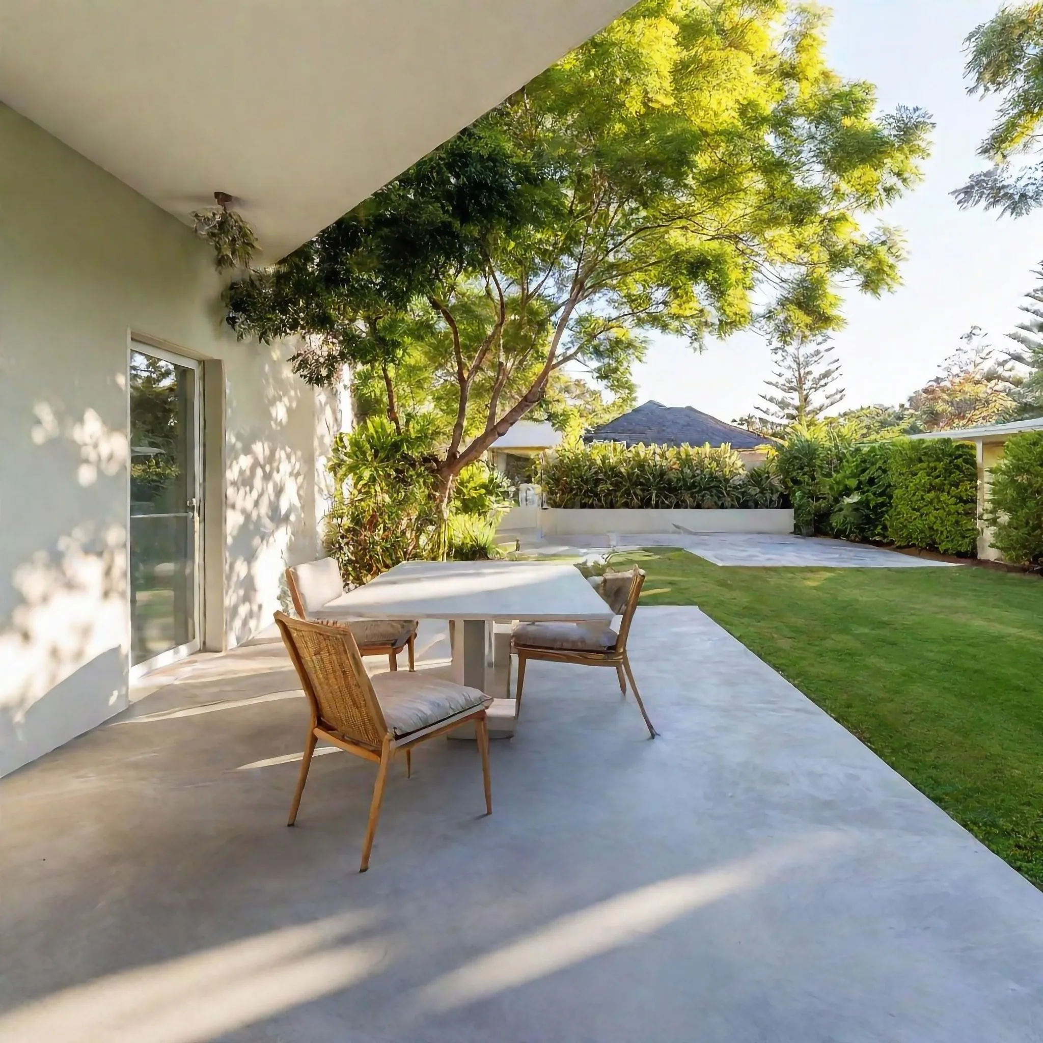 Concrete patio under a covered alfresco area with outdoor furniture